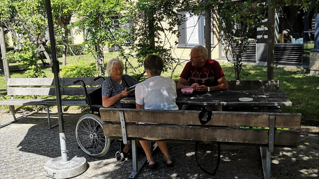 Ældre har udendørs besøg af pårørende på Plejecenter Baunehøj